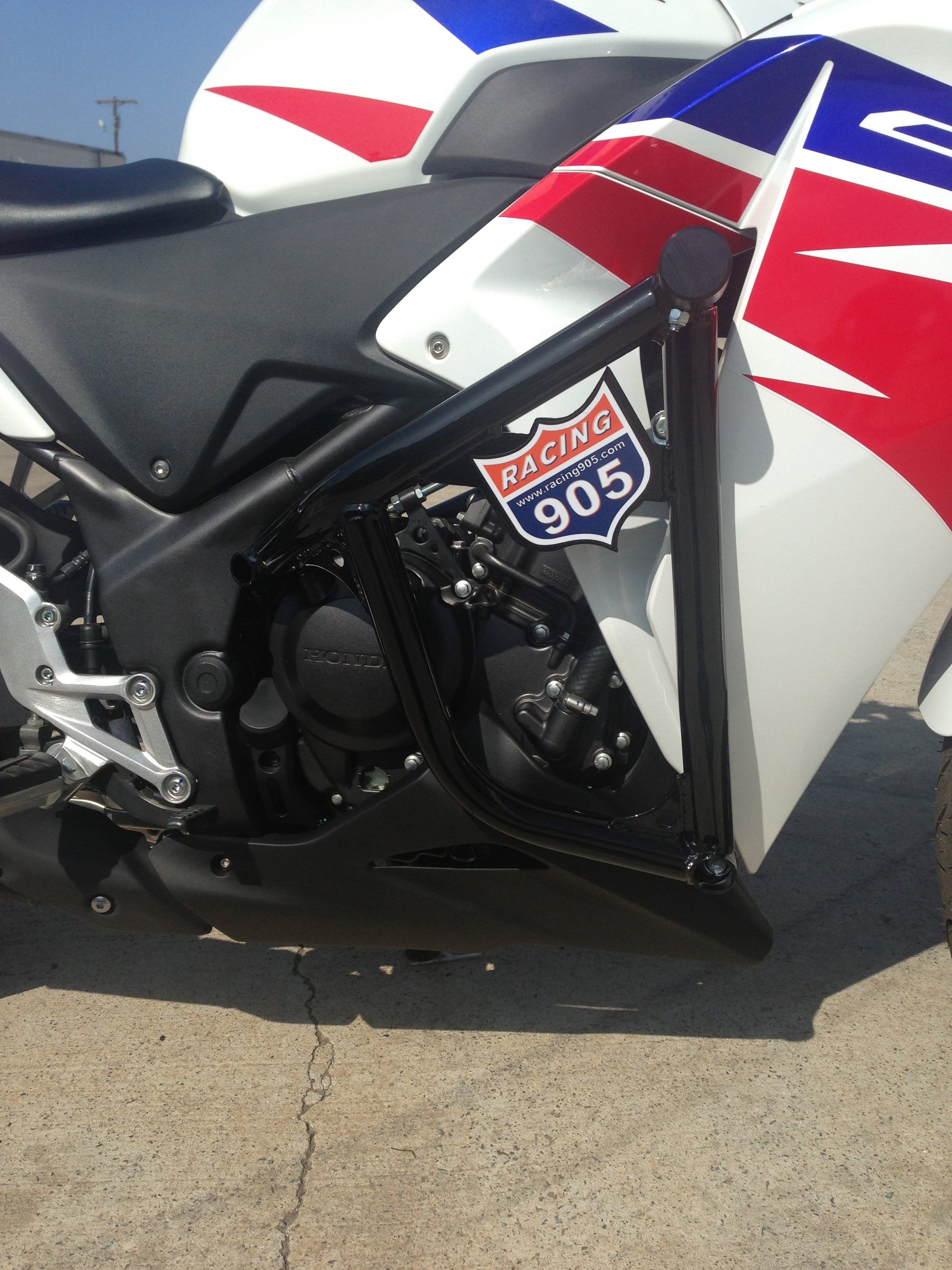 white red blue Honda 250 with cage