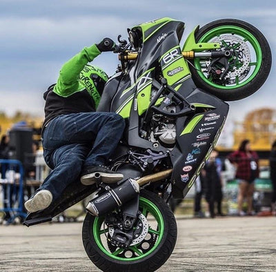 green and black Kawasaki ninja 6r stunts wheelie
